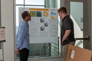 Students discussing a research poster